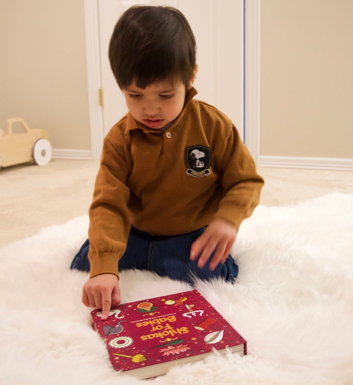 A child interacting with the Shlokas for Babies board book.